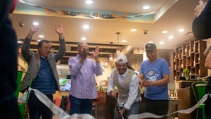 Owner Ramesh Dahal cuts the ribbon to signify the opening of Basecamp on May 27, 2022.