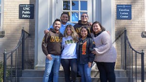 Josmell Pérez, director of the Carolina Latinx Center, poses for a portrait with members of the Latinx Center's Student Leadership Alliance on Monday, Feb. 28, 2022.
