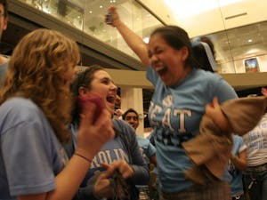 Maria Diaz reacts at the end of the Duke game on Wednesday night. Diaz was one of a crowd of students who cheered on the Heels in the Union lobby.