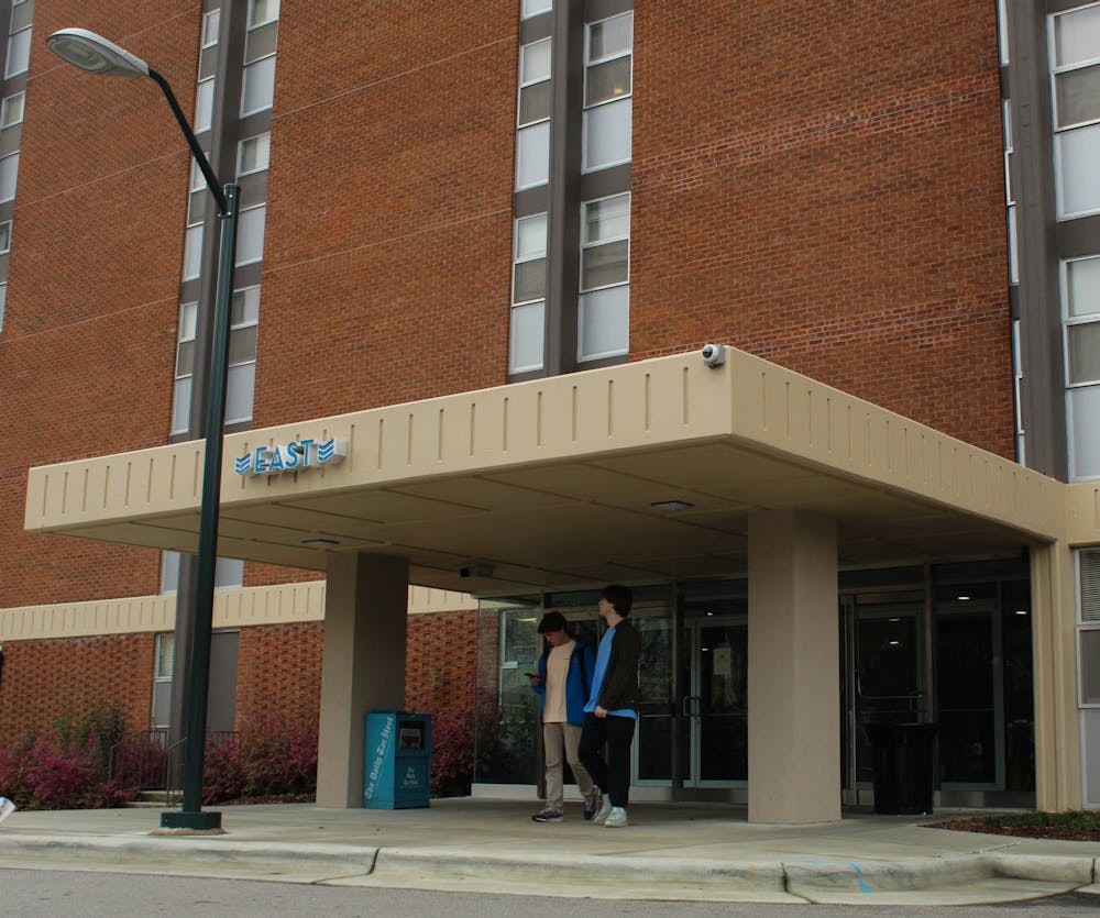 Two students exit the East building at Granville Towers on Feb. 11, 2020. Two incidents of vandalism and verbal racial harassment were recently reported at Granville Towers that are now under investigation by UNC Police.