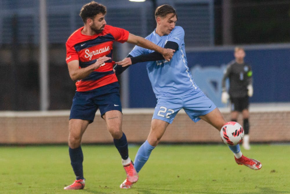 Senior midfielder Milo Garvanian (22) fights for the ball at the first round of the ACC playoffs against Syracuse on Nov. 3 at Dorrance Field. The Tar Heels won in a 2nd overtime 1-0.