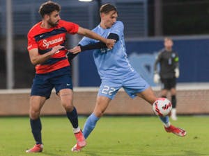 Senior midfielder Milo Garvanian (22) fights for the ball at the first round of the ACC playoffs against Syracuse on Nov. 3 at Dorrance Field. The Tar Heels won in a 2nd overtime 1-0.