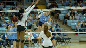 UNC junior middle hitter Kaya Merkler (14) spikes the ball during the game against Florida State on Oct. 2, 2022. UNC lost to Florida State 2-3.