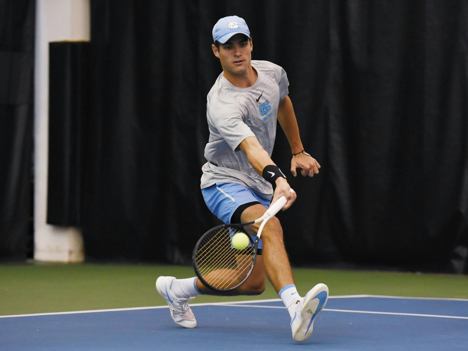 Ladd Harrison swings during a match against NCCU at the Cone-Kenfield Tennis Center on Saturday, Jan. 18, 2020. Photo courtesy of Rebecca Lawson/GoHeels.