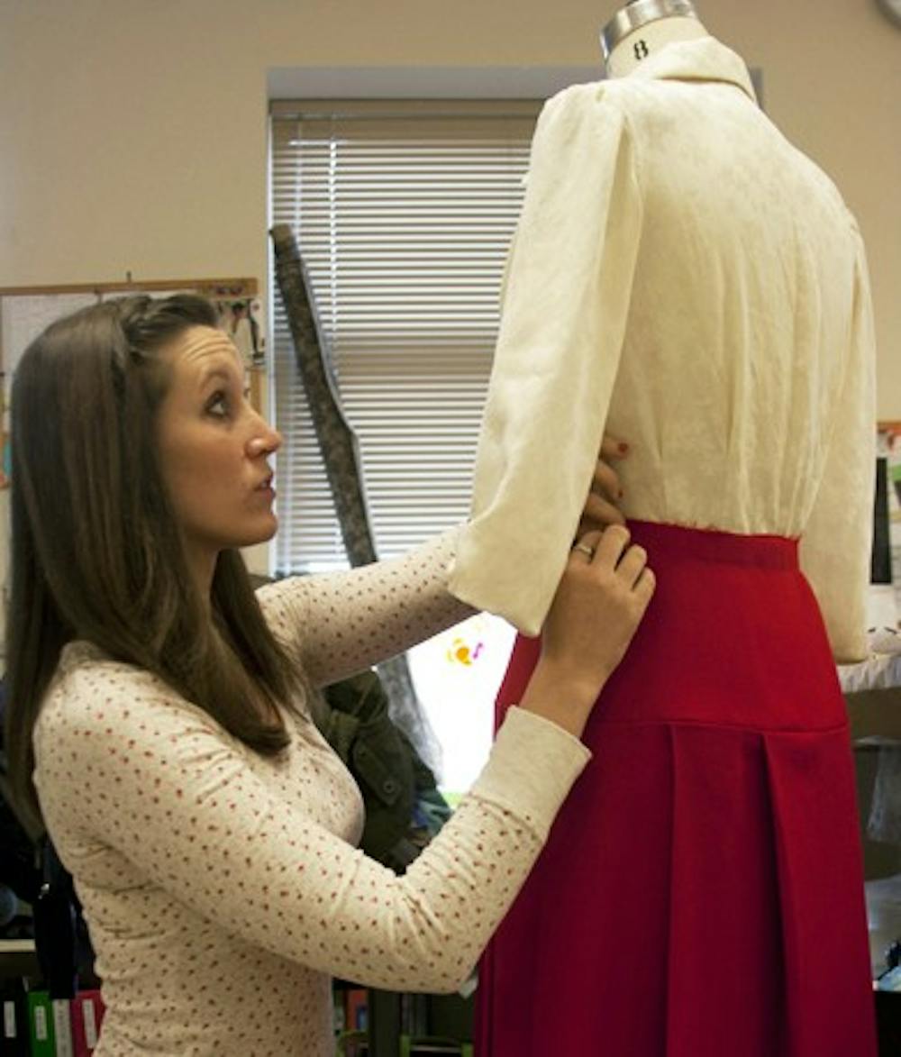 	<p>Kelly Renko, a second-year graduate student in the <span class="caps">UNC</span> costume production program, adjusts the costume of the Mary Hatch Bailey character.</p>