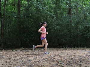 Mariana Lucena runs at the UNC Cross Country Course at Finley Fields.