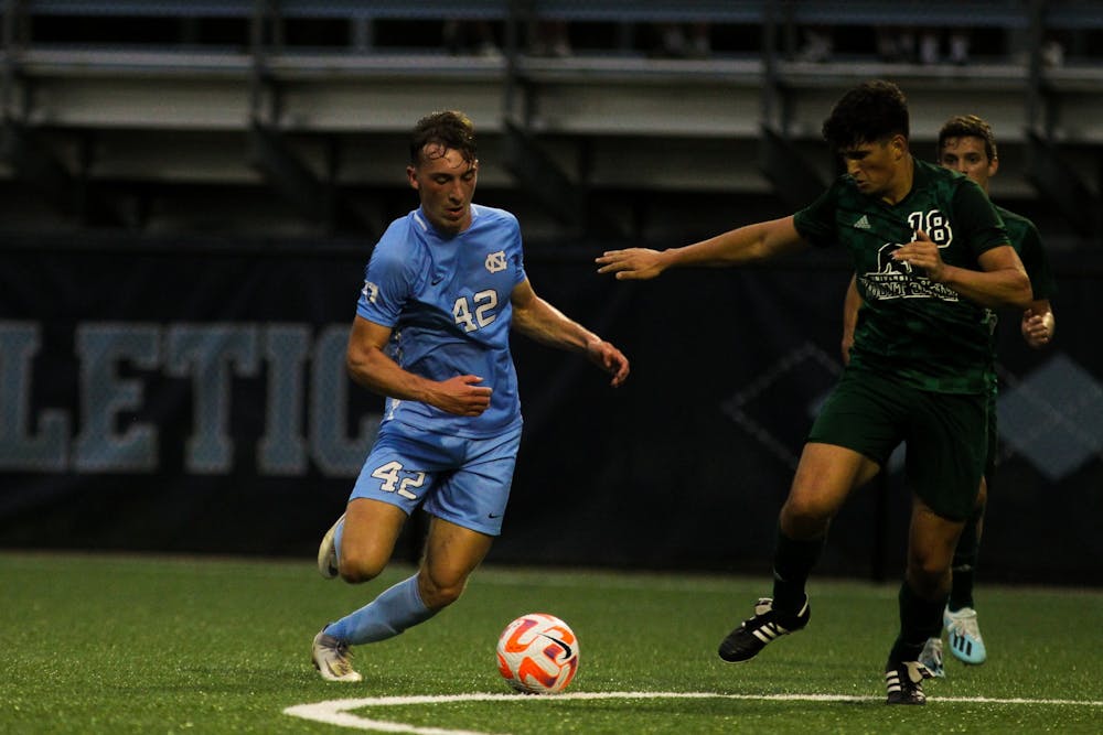 <p>UNC sophomore forward Daniel Kutsch (42) shoots during the Tar Heel's exhibition against Mount Olive at Finley Soccer Field Center on Aug. 15, 2022. The Heels tied 1-1.</p>