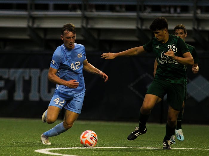 UNC sophomore forward Daniel Kutsch (42) shoots during the Tar Heel's exhibition against Mount Olive at Finley Soccer Field Center on Aug. 15, 2022. The Heels tied 1-1.