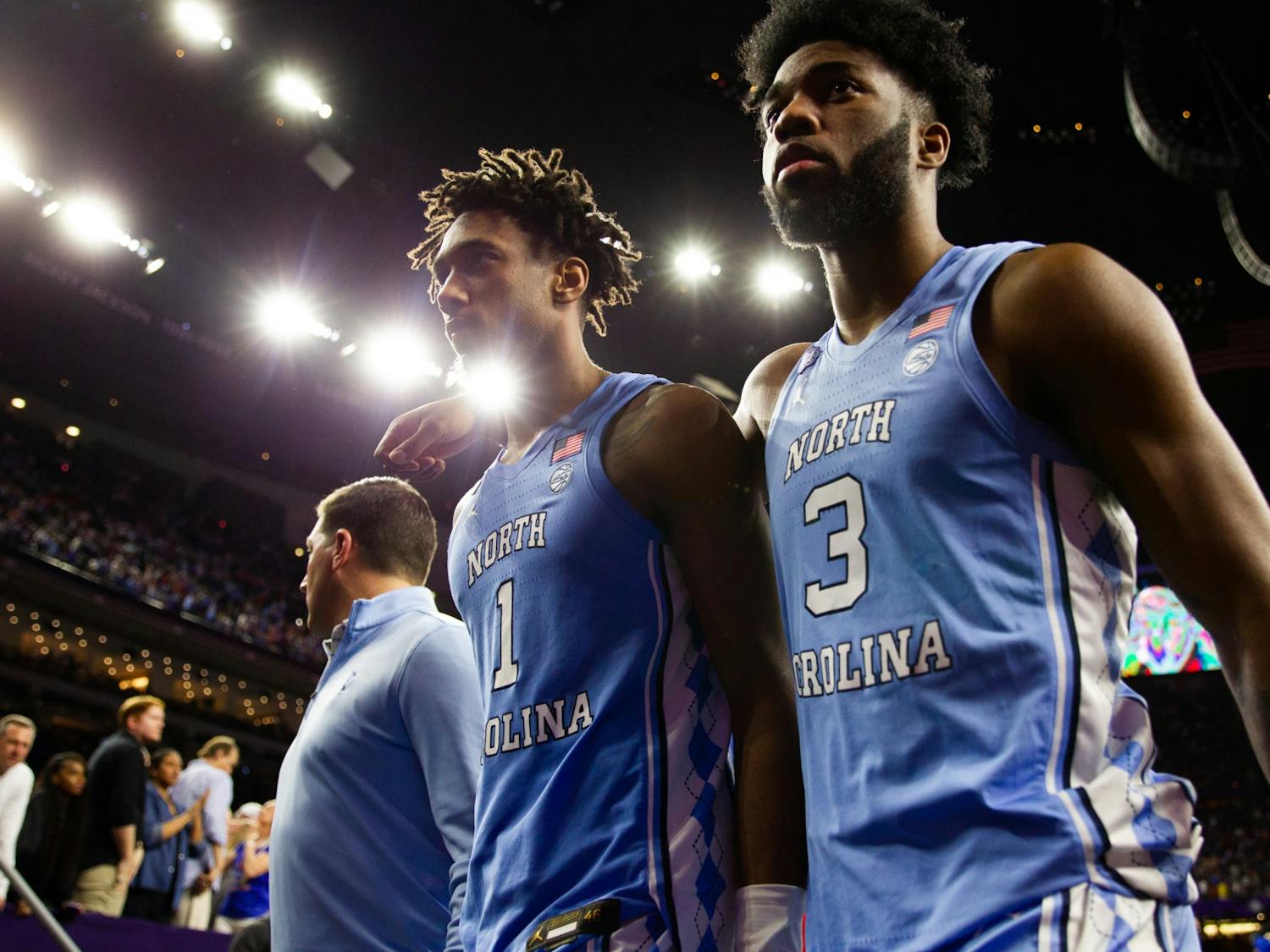 UNC senior forward Leaky Black (1) and first-year guard Dontrez Styles (3) exit the court after an NCAA championship game against Kansas in New Orleans on Monday, April 4, 2022. UNC lost  72-69.