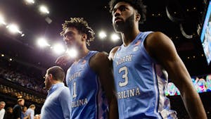 UNC senior forward Leaky Black (1) and first-year guard Dontrez Styles (3) exit the court after an NCAA championship game against Kansas in New Orleans on Monday, April 4, 2022. UNC lost  72-69.