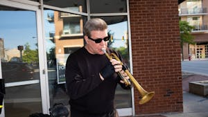 Chris, the trumpet monk, playing his rendition of a Louis Armstrong piece at sunset by the corner of Chapel Hill Florist in Chapel Hill, N.C. on April 25th, 2023.