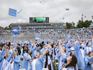 UNC 2022 graduates toss their caps at the end of the spring commencement ceremony on May 8. Photo courtesy of Johnny Andrews via UNC Media Relations.