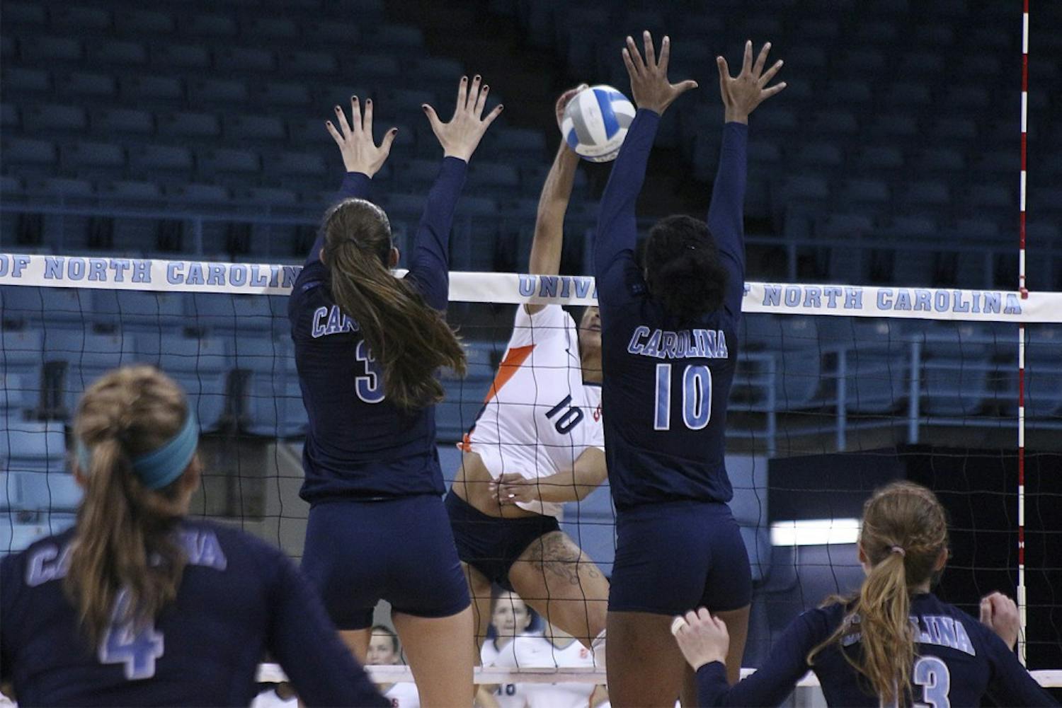 Beth Nordhorn and Chaniel Nelson attempt to block a spike during Sunday afternoon's win over Syracuse. 
