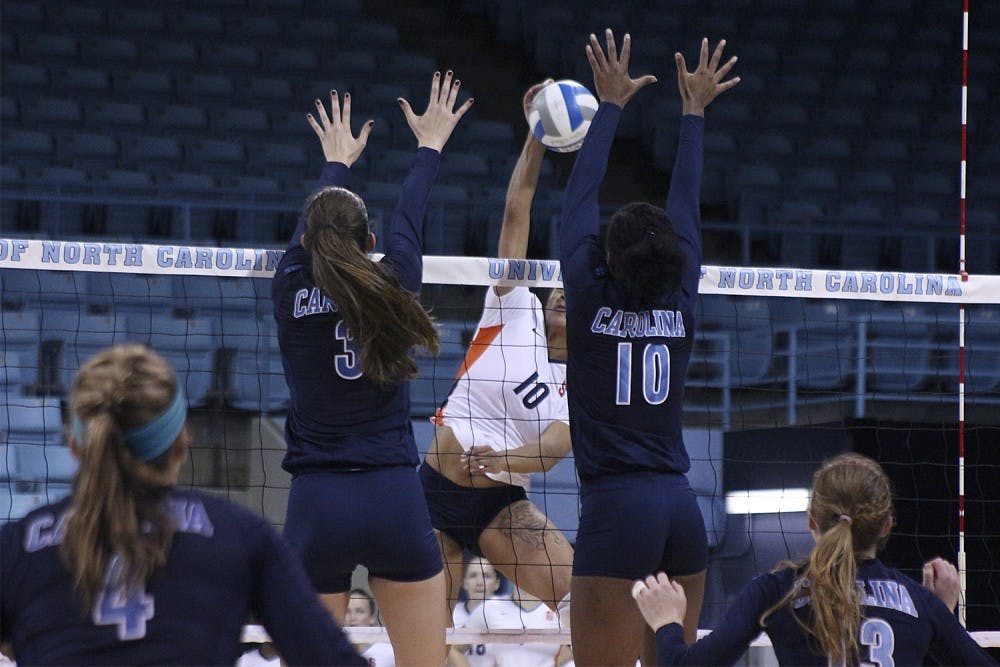 Beth Nordhorn and Chaniel Nelson attempt to block a spike during Sunday afternoon's win over Syracuse. 