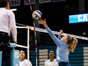 Freshman outside hitter Mabrey Shaffmaster (9) taps the ball over the net in the senior day match against the University of Miami on Sunday, Nov. 21, 2021. The Tar Heels fell to the Hurricanes in a five-set match.