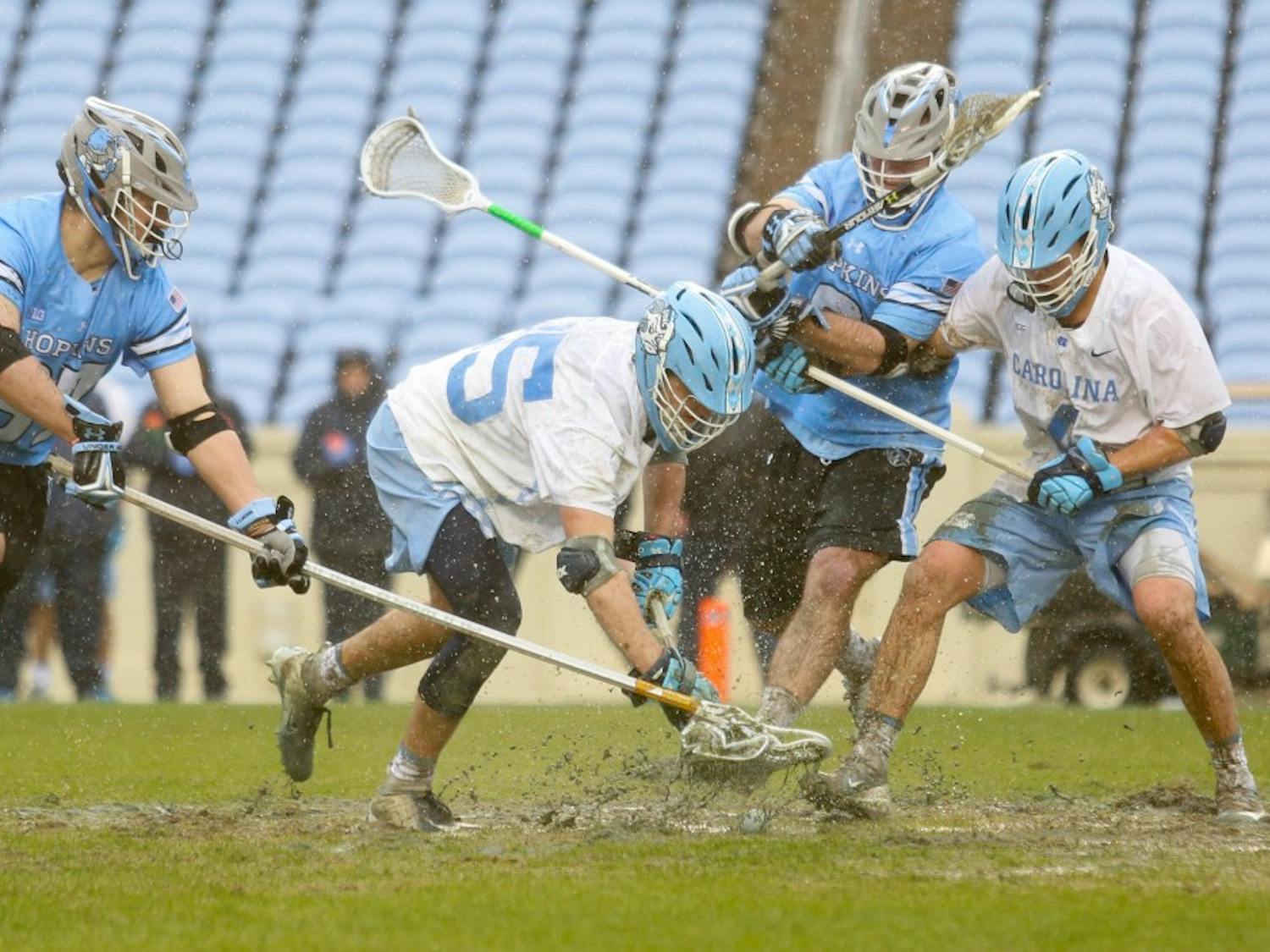 Midfielder Zachary Tucci (35) fights for the ball following a face-off during the game against Johns Hopkins on Saturday, Feb. 24, 2019. Johns Hopkins defeated the Tar Heels 11-10.