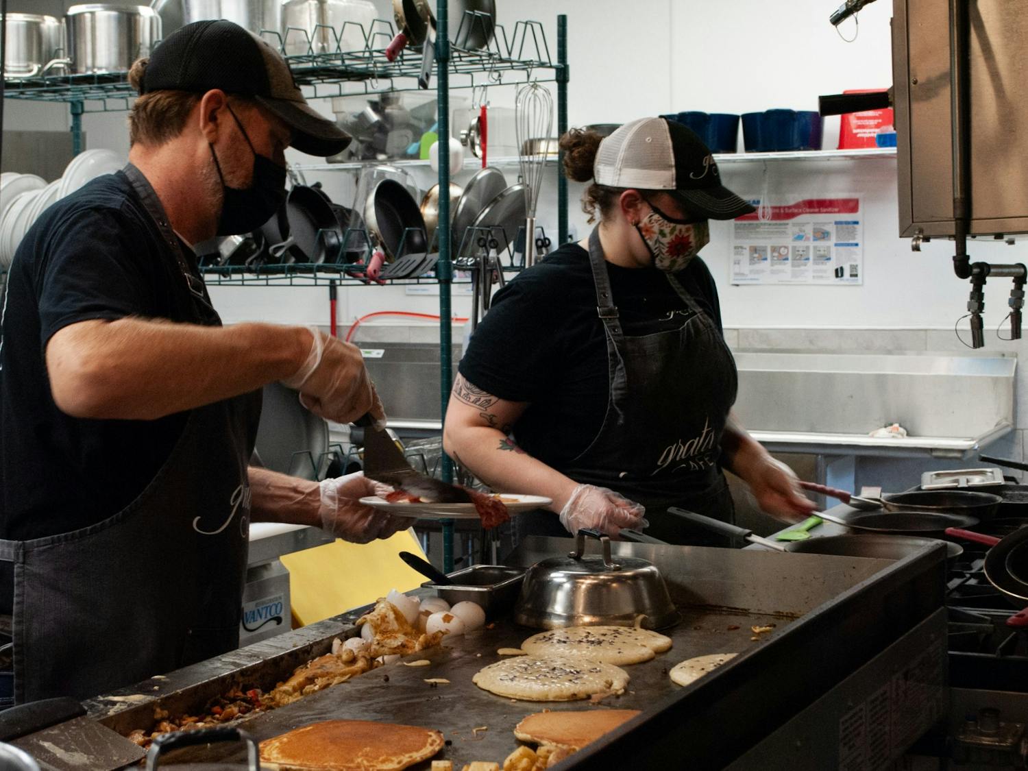 Chefs prepare food at the new Grata Cafe in Carrboro recently opened on Sunday, August 8th. Owner Jay Radford says that "the staff are amazing and the food... the food is just great."