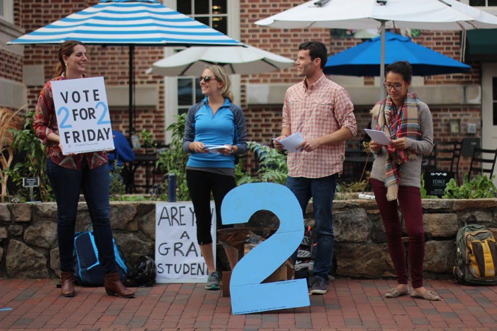 From left: Graduate students Emily Brennan Moran, Kasia Grzebyk, Brett Winters, and Amy Lin encourage students in the pit to vote to divide student government.