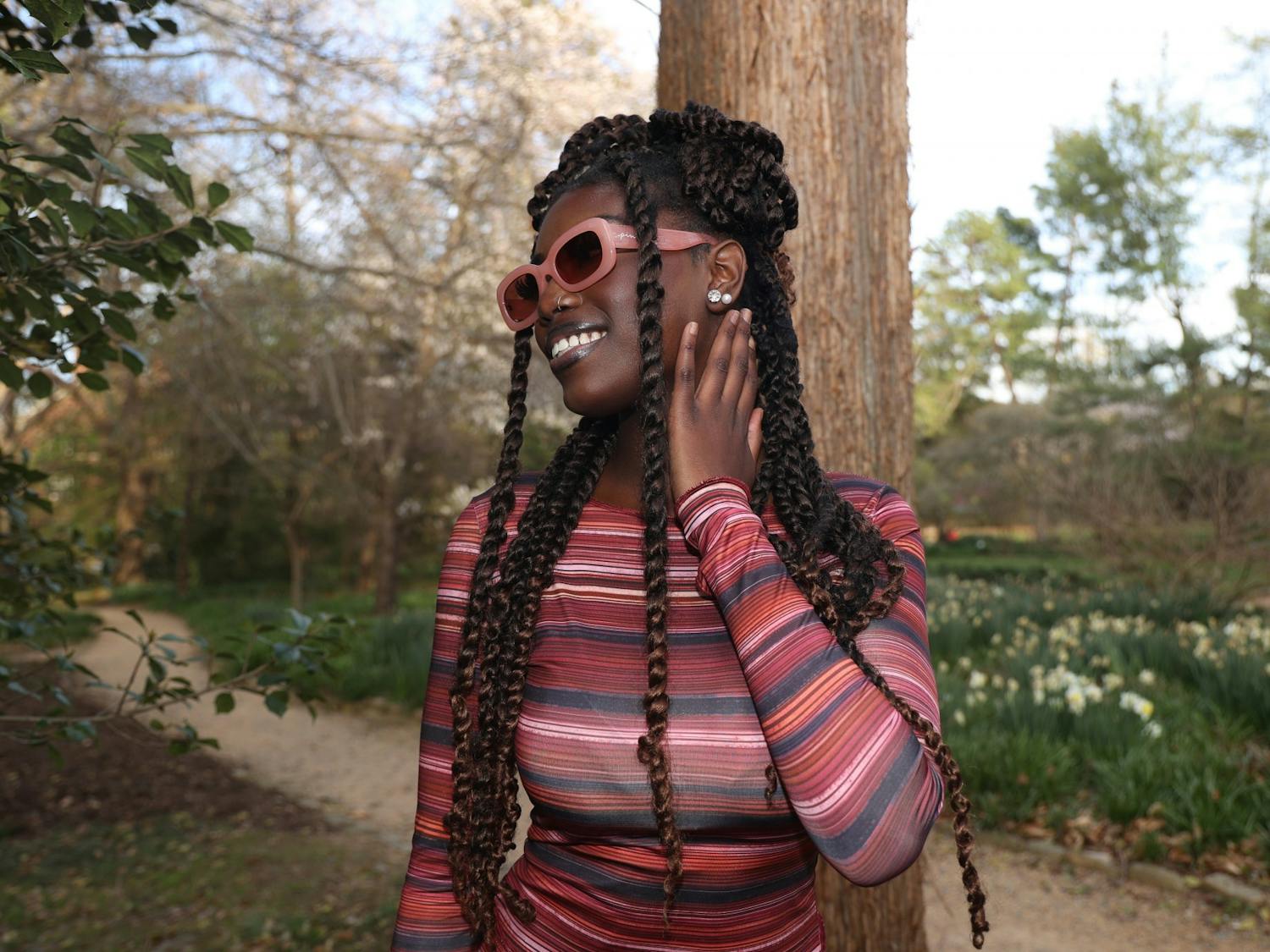 UNC sophomore Jaziah Planter shows off her pink sunglasses and outfit in Coker Arboretum on Friday, March 20, 2023.