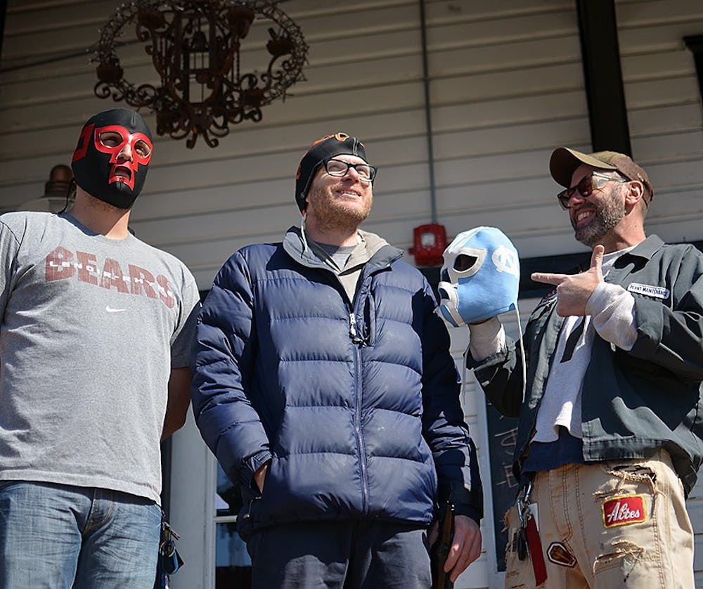  Alex Freeman (left), Chip Hoppin (middle), Mike Benson (right), and Mike Tyrrell (not pictured), own a mask making business in Carrboro. They have been making masks for ten years. 