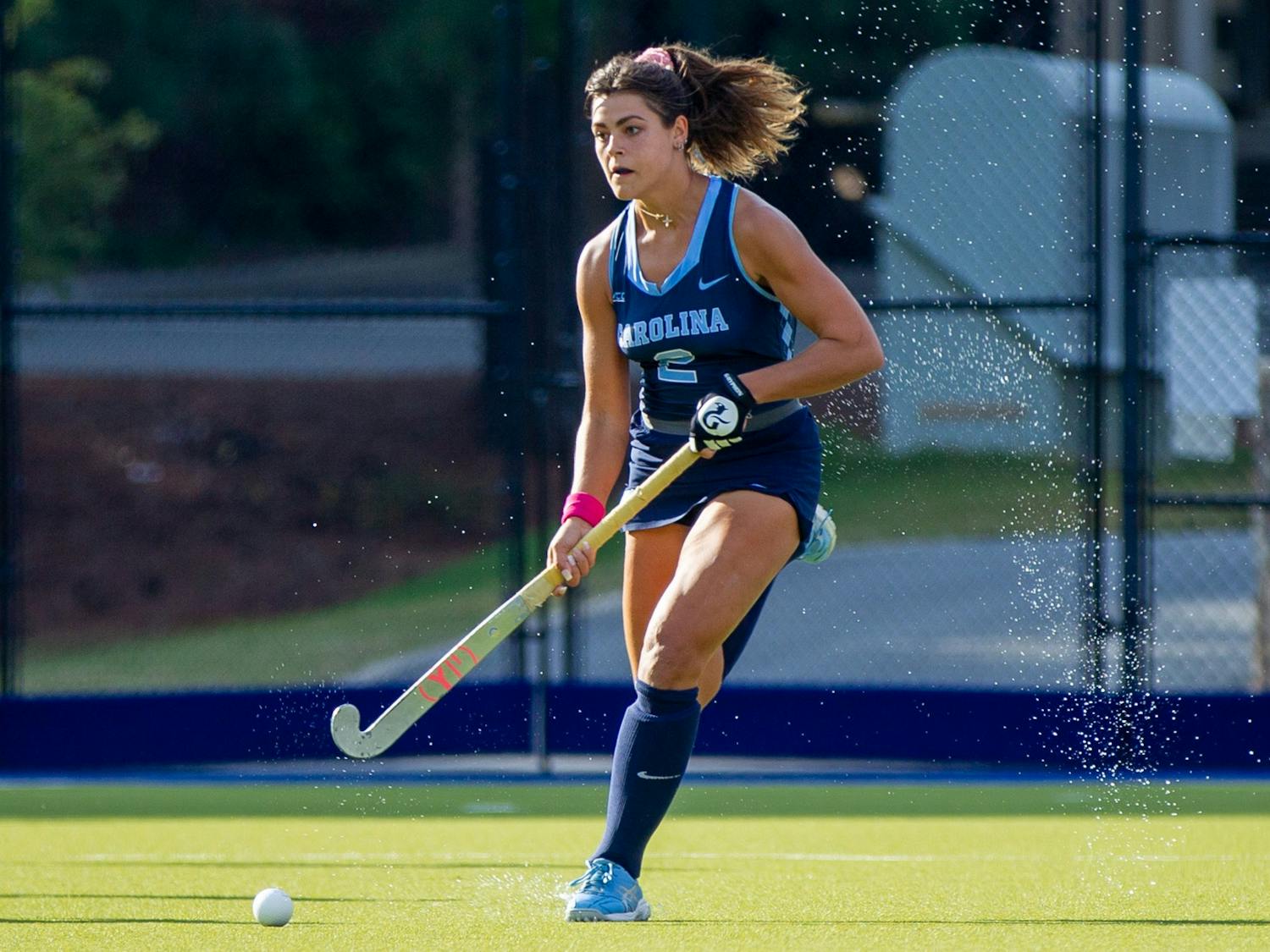 Senior forward Meredith Sholder (2) runs with the ball at the field hockey game against Louisville on Oct. 22 at the Karen Shelton Stadium. UNC lost 2-3 in overtime.