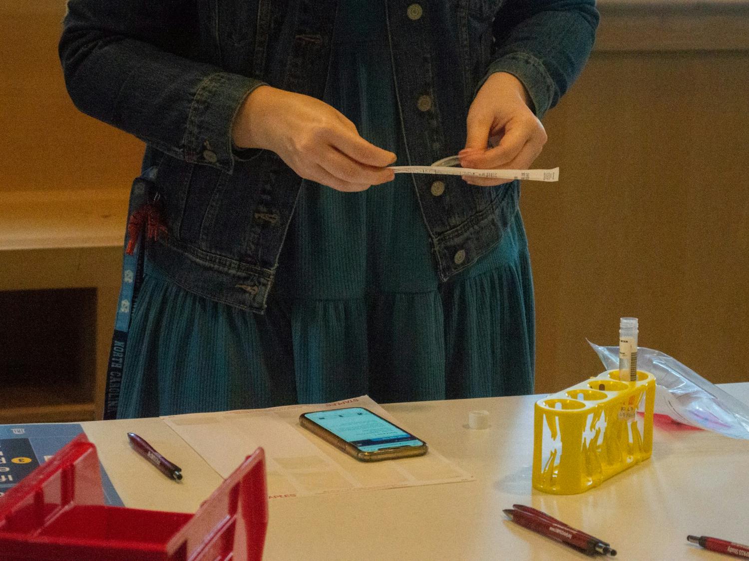 A student opens the testing swab while taking a COVID-19 test at the Rams Head Recreation CTTP testing site on Jan. 19, 2021.