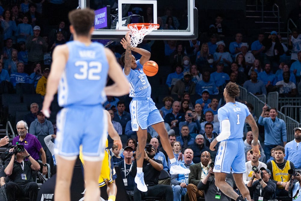 UNC senior forward/center Armando Bacot (5) dunks the ball during the men's basketball game against Michigan at the Jumpman Invitational in Charlotte, N.C., on Wednesday, Dec. 21, 2022. UNC beat Michigan 80-76.