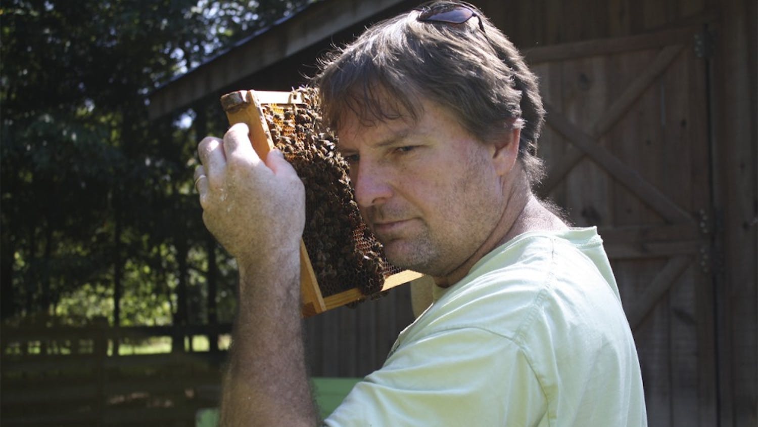 Marty Hanks, the creator of "Just Bee Apiary," a bee farm located on his land just outside of downtown Chapel Hill, checks on his honeybees. Hanks makes it a priority to raise his thousands of bees without the use of unnatural chemicals.

