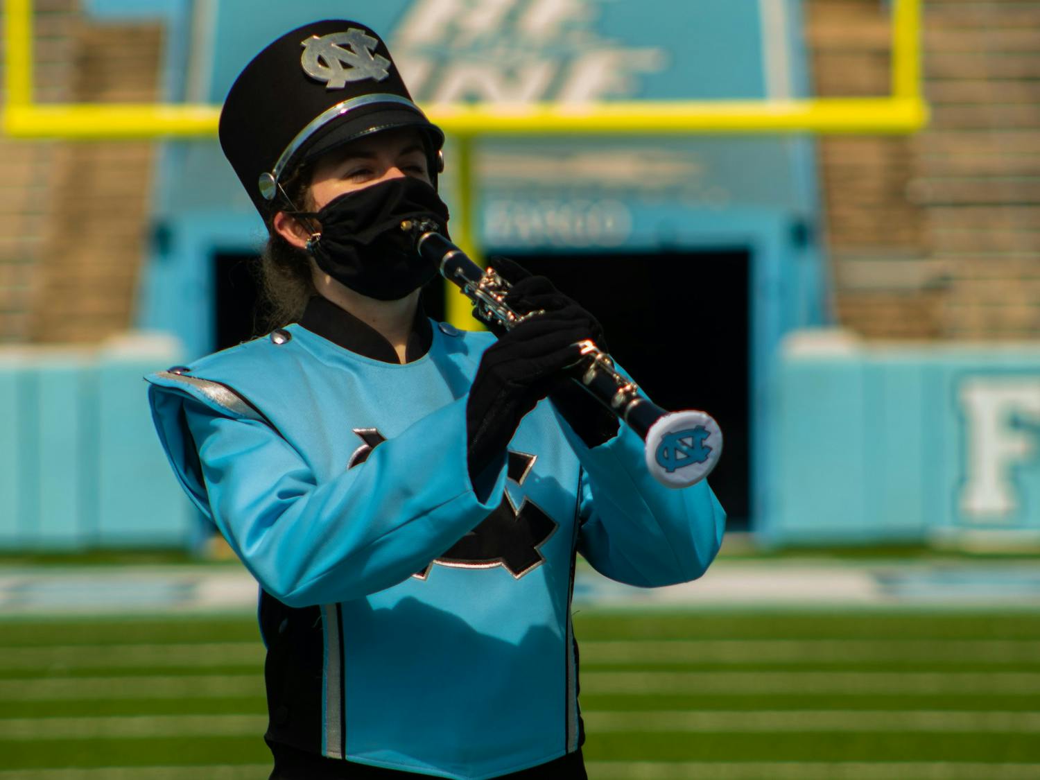Sophomore Madi Marks plays a scale on her clarinet while demonstrating the new safety precautions the Marching Band must take to protect against COVID.