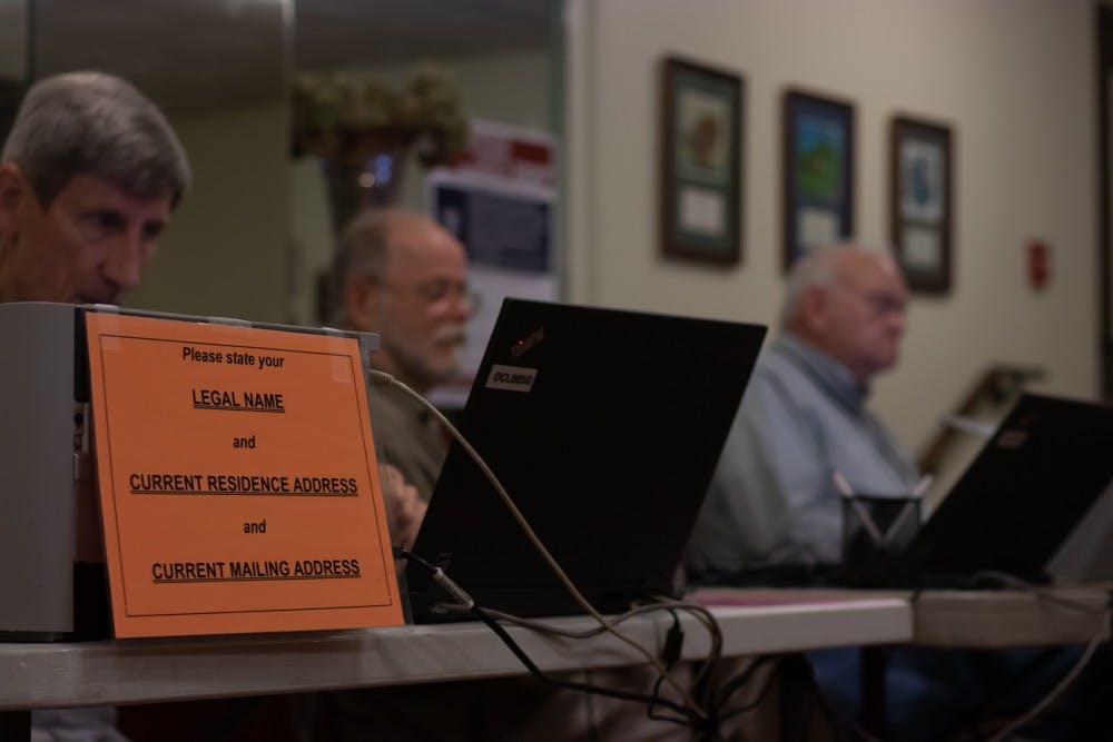 Orange County Election officials, Ed Tostanoski, Dirk Kelder, and Joe Jackson wait to help early voters cast their vote at Chapel of the Cross church at 304 Franklin St. on Wednesday, Oct. 30, 2019.