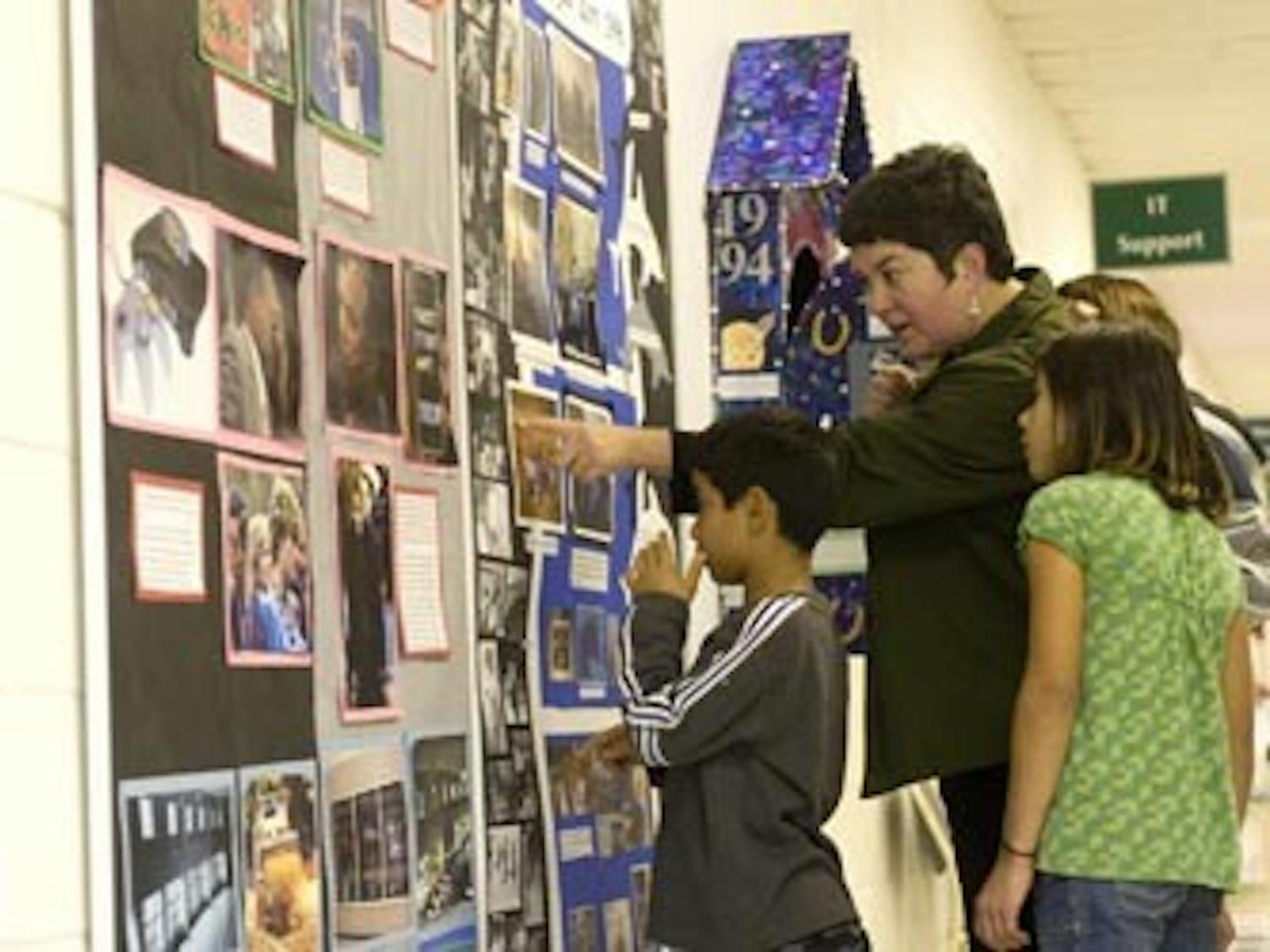 Parents and students came to an exhibit of student art celebrating the 100th Anniversary of the Carrboro School System.