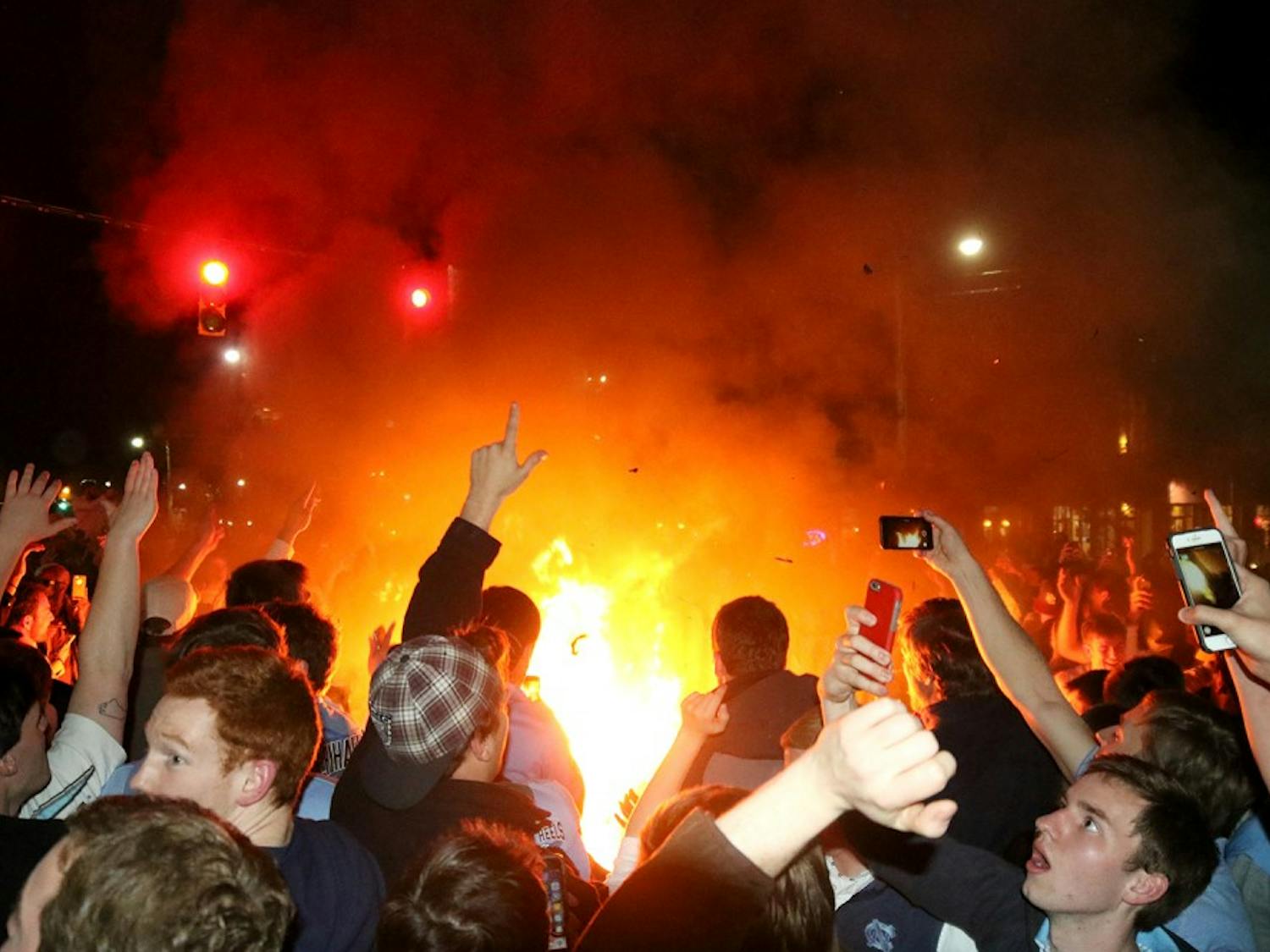 Students and Carolina basketball fans rush Franklin St. after defeating Duke. The students set bonfires to jump over.