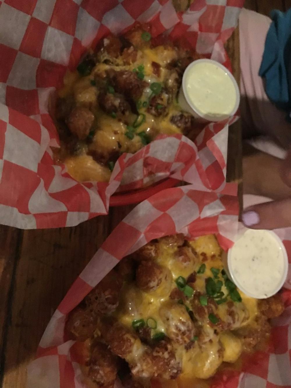 <p>The loaded sweet potato tots, left, and the loaded regular tots at Linda's.</p>