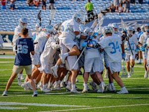 The UNC men's lacrosse team storms the field after the Tar Heels' 15-12 victory against Duke on Sunday, May 2. With the victory, UNC and Duke share the 2021 ACC regular season title.
