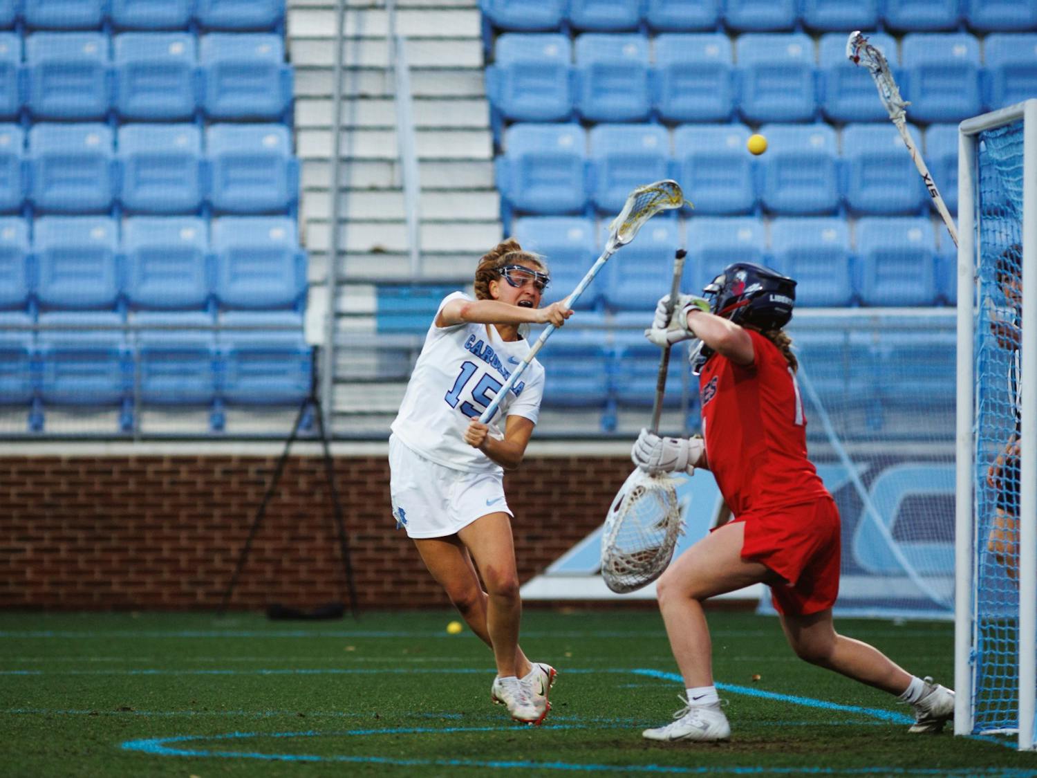 UNC attacker Caitlyn Wurzburger (15) scores during the second quarter of the women's lacrosse match against Liberty. UNC led 11-4 at half at Dorrance Field. Photographed on Wednesday, Feb. 15, 2023.