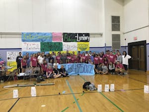 Attendees of Relay for Life 2018 of UNC event gather in front of a sign displaying the amount raised. Photo by Madison Buchanan.