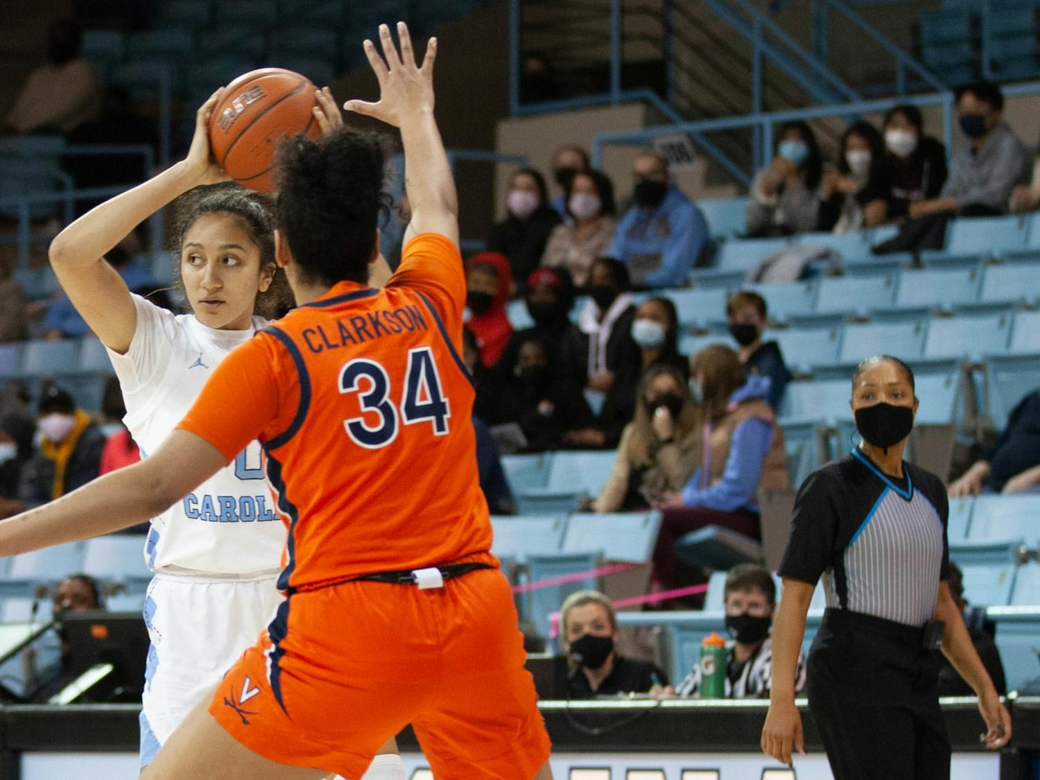 UNC sophomore forward Alexandra Zelaya (0) is guarded by a Virginia player at the game against UVA at Carmichael Arena on Jan. 20 2022. The Tar Heels' beat the Cavaliers 61-52.