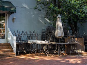Stacked chairs and picnic tables sit unused in the outdoor eating area of Famous Toastery in Davidson, NC on Thursday, May 14, 2020. Restaurants Restaurants like this and many other businesses across the state are losing business due to the COVID-19 pandemic.