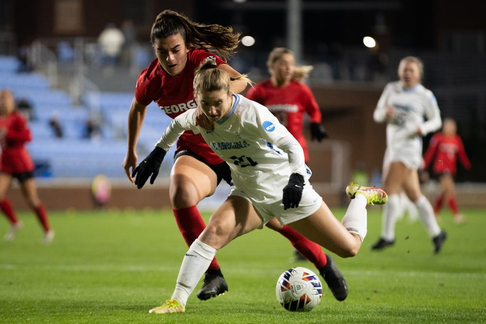 <p>UNC redshirt first-year Ally Sentnor (21) protects the ball during the women's soccer game against Georgia on Thursday, Nov. 17, 2022, at Dorrance Field. UNC beat Georgia 3-1.</p>