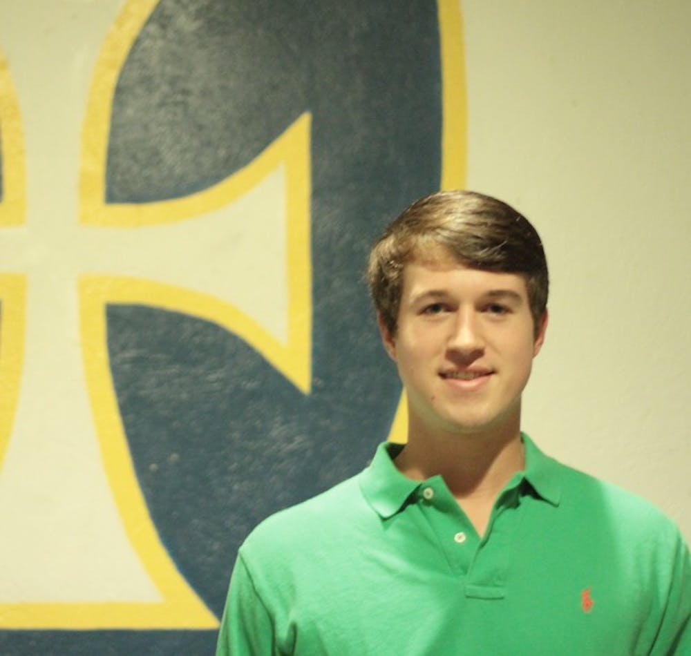 IFC President Brent Macon stands in front of the emblem of his fraternity, Sigma Chi, on Sunday.