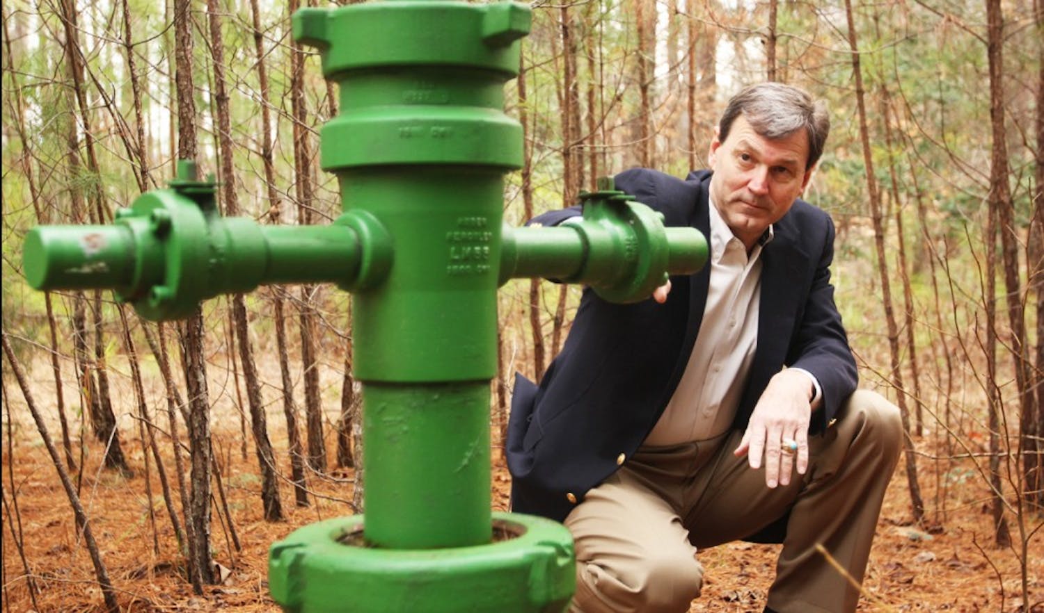	Lee County Commissioner and Mining and Energy Commission Chairman Jim Womack examines a gas well near Chatham County.