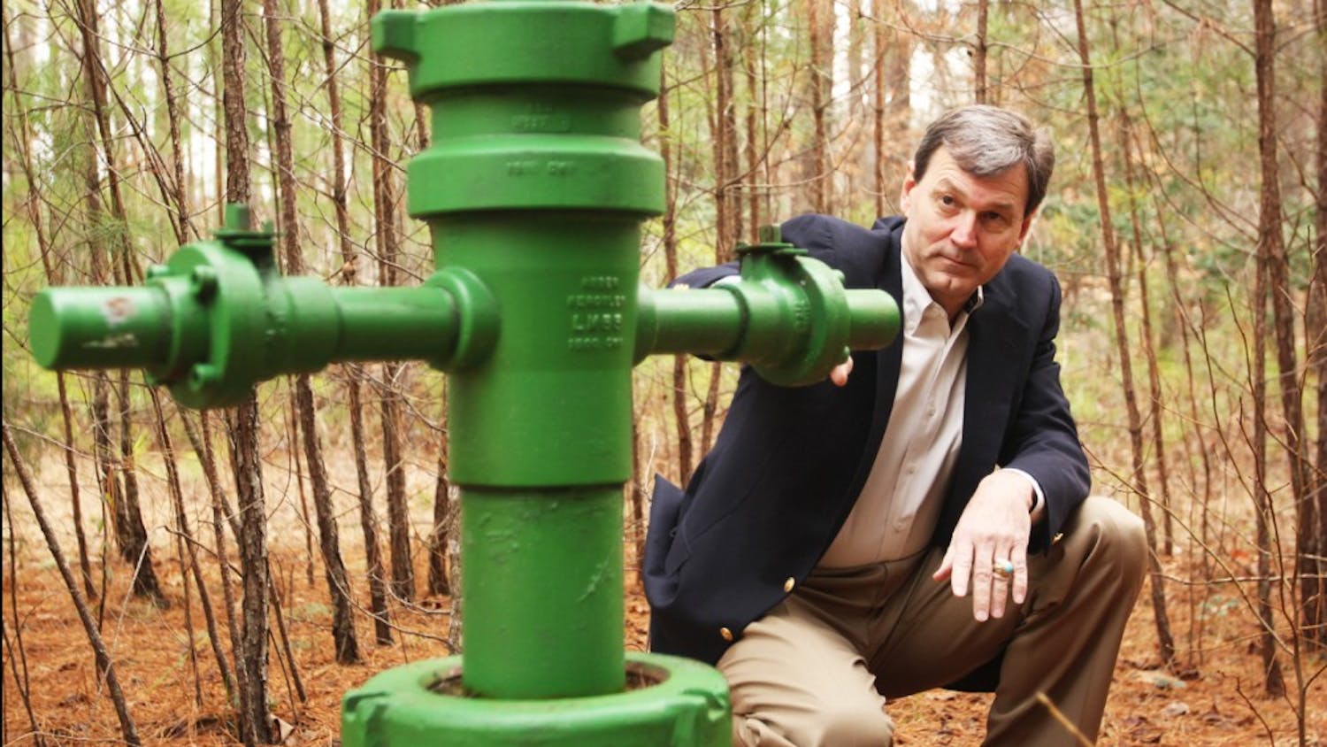 	Lee County Commissioner and Mining and Energy Commission Chairman Jim Womack examines a gas well near Chatham County.