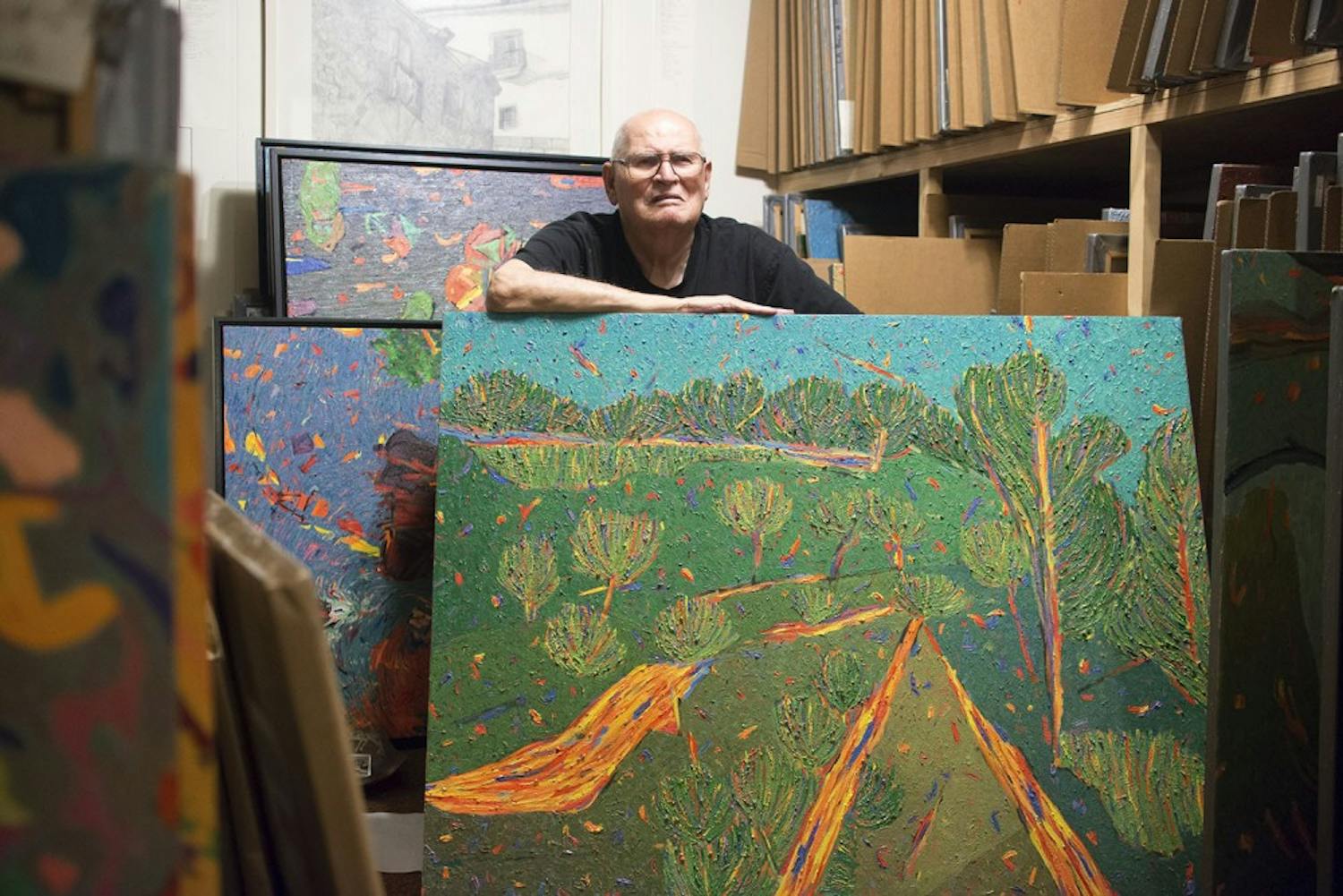 Marvin Saltzman poses with his artwork in his studio, located in Chapel Hill on July 22nd. A small portion of Saltzman's thousands of pieces is currently on display in the Eno Gallery in Hillsboro. 

"I draw from nature, and then I paint about nature."
"Bad teachers train, good teachers open doors."