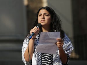 Aisha Jitan, a junior global studies major and Islamic & Middle East studies minor, addresses a crowd at a protest on the steps of South Building on Wednesday, Sept. 25, 2019. Demonstrators gathered against the Department of Education's demands to recast the tone of Duke University's and UNC-Chapel Hill's Middle East Studies program. Regarding the Department's rhetoric as Islamophobic, Jitan remarked: "We were really angry about what we read, especially given that we lost three Muslim people in our community not too long ago due to Islamophobia, and then after reading and hearing this, we were just angry and said we want better for our community."