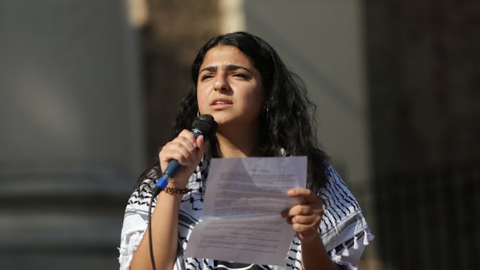 Aisha Jitan, a junior global studies major and Islamic & Middle East studies minor, addresses a crowd at a protest on the steps of South Building on Wednesday, Sept. 25, 2019. Demonstrators gathered against the Department of Education's demands to recast the tone of Duke University's and UNC-Chapel Hill's Middle East Studies program. Regarding the Department's rhetoric as Islamophobic, Jitan remarked: "We were really angry about what we read, especially given that we lost three Muslim people in our community not too long ago due to Islamophobia, and then after reading and hearing this, we were just angry and said we want better for our community."