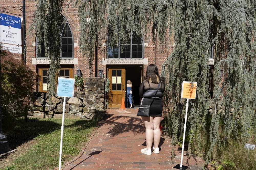 <p>A UNC student stands in line to vote early at Chapel of the Cross on Franklin Street on Thursday, Oct. 15, 2020.</p>