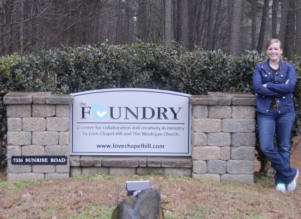 Allison Norman, a graduate student and founder of Made with Love Bakery, stands in front of the Foundry sign on Tuesday afternoon. The Foundry is the building that will house the bakery.