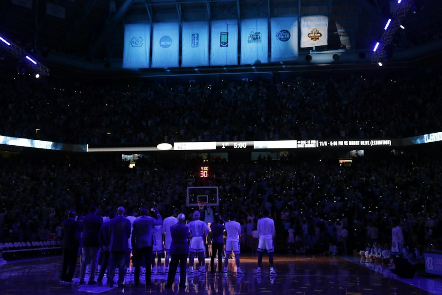 The UNC men's basketball team watches as the 2017 NCAA Men's Basketball National Championship banner is revealed in the Dean Smith Center during Late Night With Roy on Friday night.&nbsp;