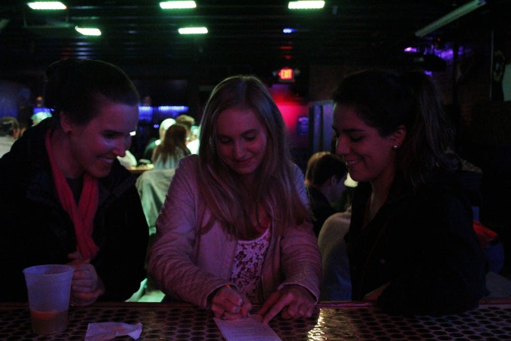 From left,&nbsp;Paola Vallejos, Erin Brown and Kate Abendroth participate in "Mean Girls Trivia" at Country Fried Duck on Monday night.&nbsp;