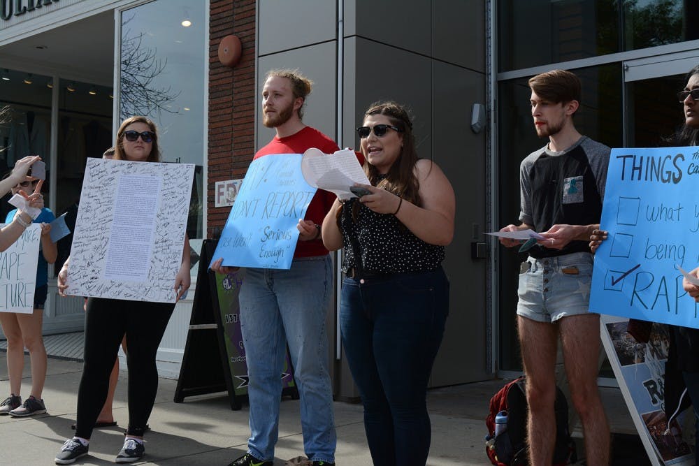 <p>Sammie Espada, a junior women's and gender studies and poll sic double major, reads out grievances addressed to the Equal Opportunity and Compliance Office as protesters watch on in 2017.</p>